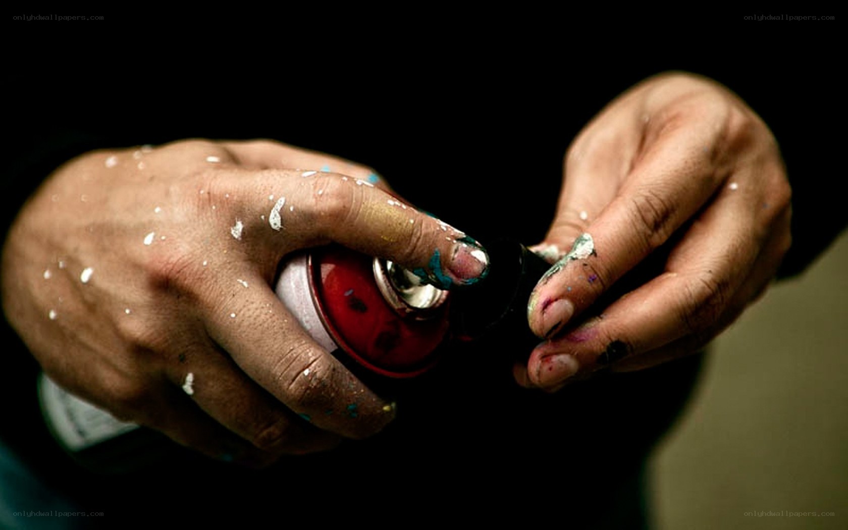 hands with spray paint