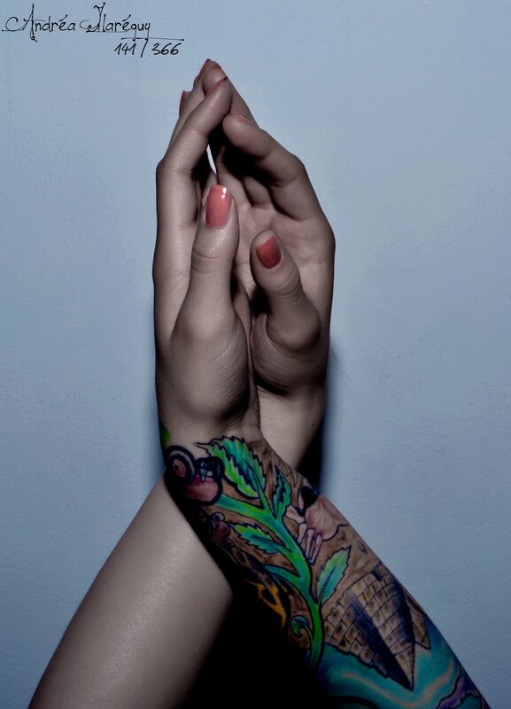 Hands with tattooed arm