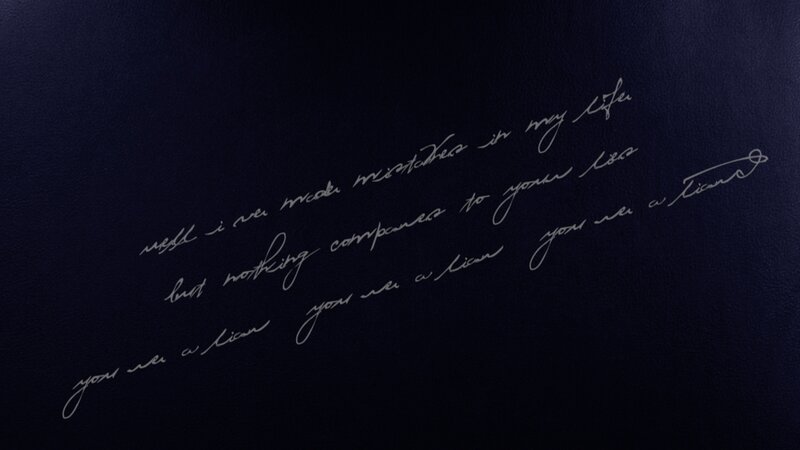 Handwritten Text on Dark Surface