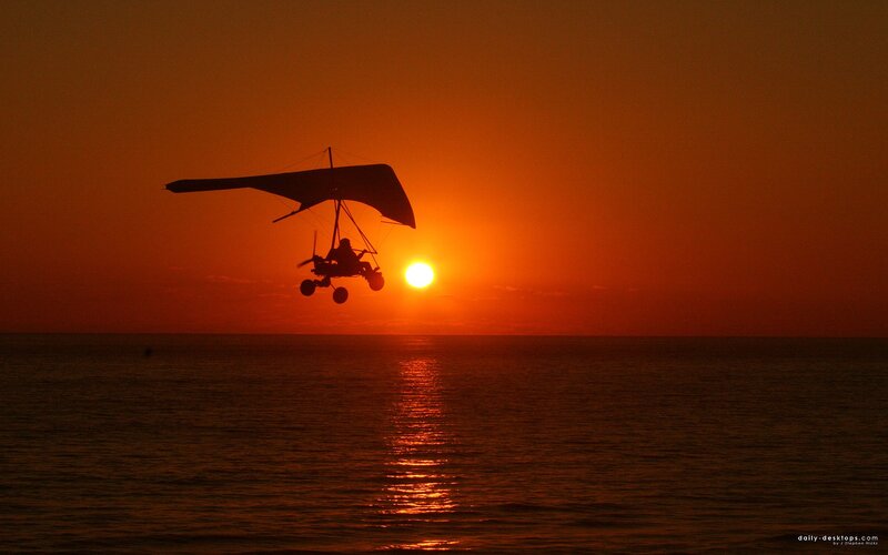 Hang glider at sunset