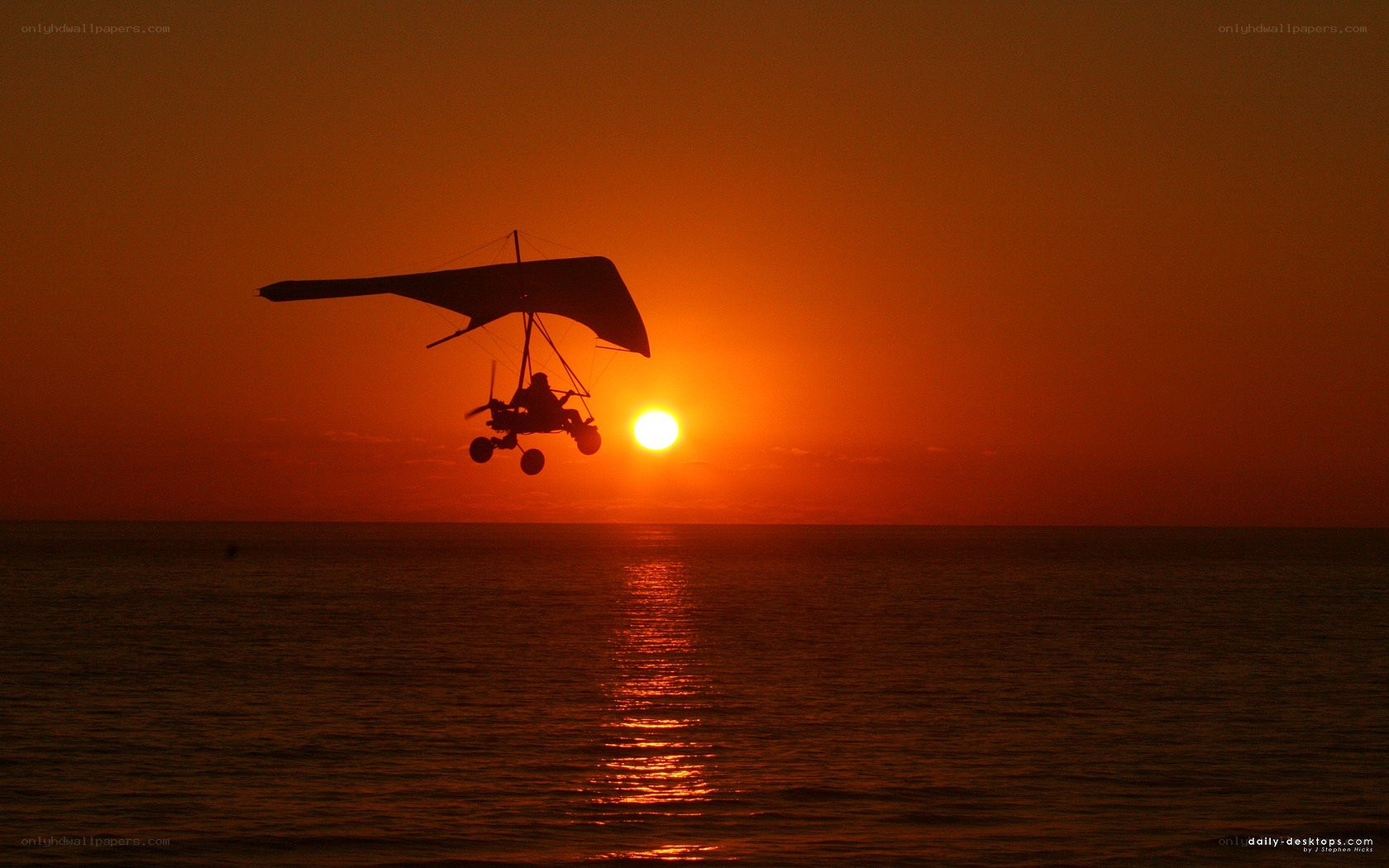 Hang glider at sunset