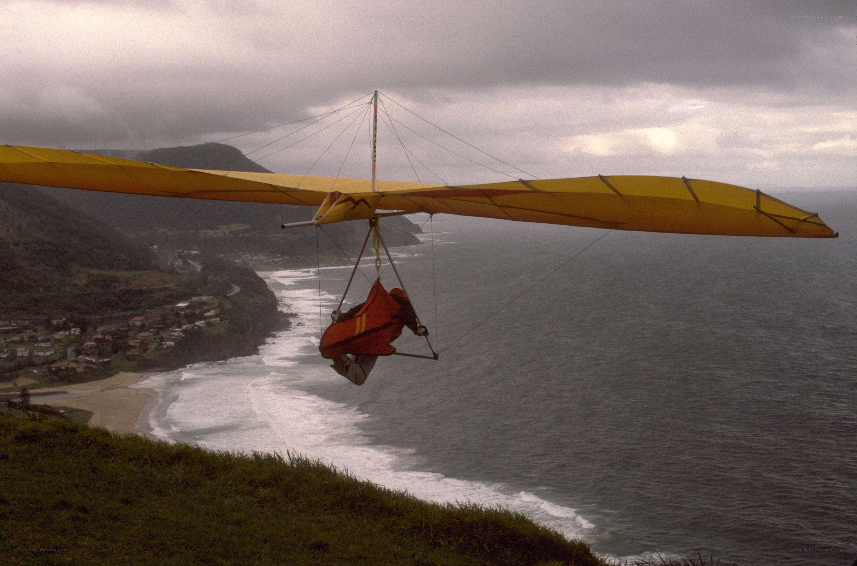 Hang glider over coastal cliffs