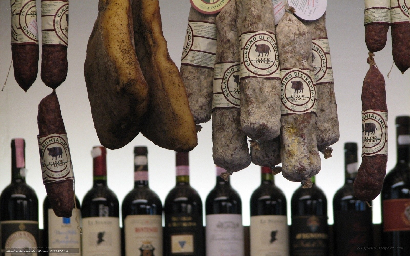 hanging cured meats and wine bottles