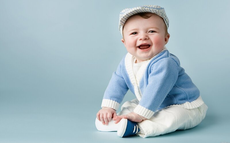 happy baby in blue sweater