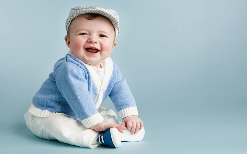 happy baby in blue sweater