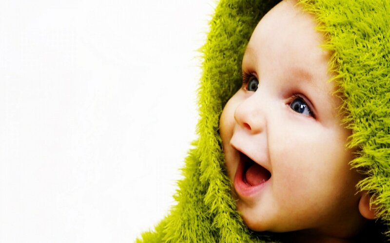 happy baby in green hood