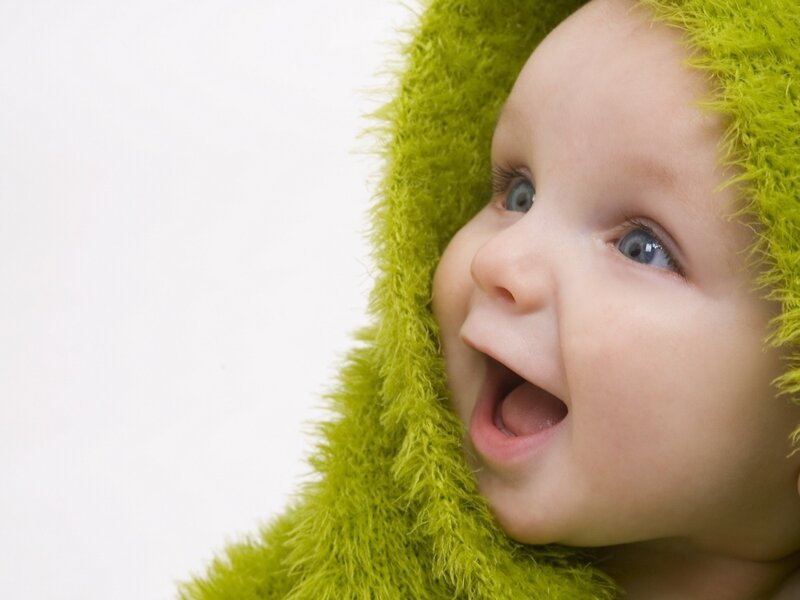 happy baby in green hood