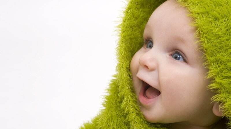 happy baby in green hood