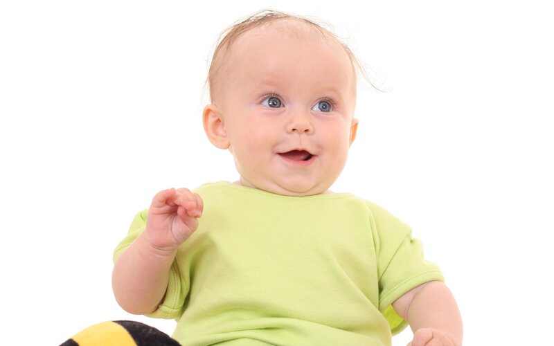 happy baby in green shirt