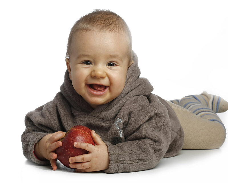 happy baby with red apple