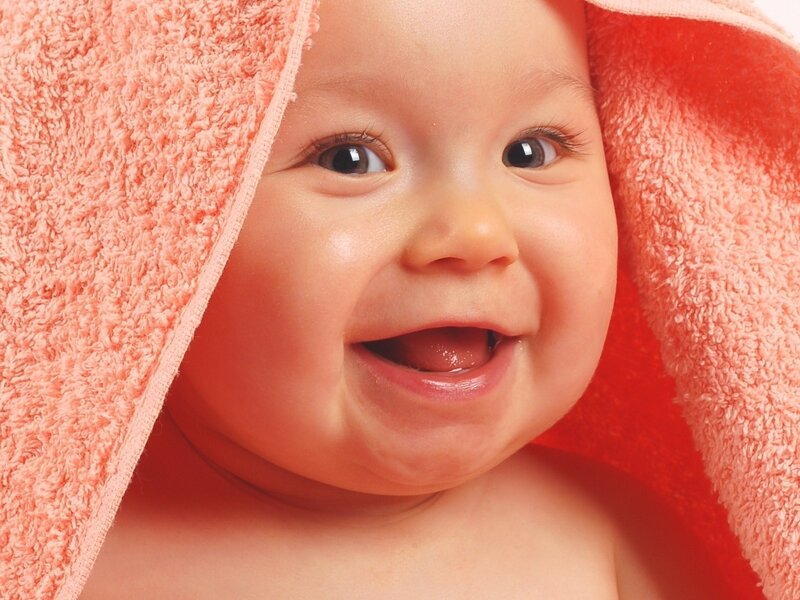 happy baby wrapped in towel