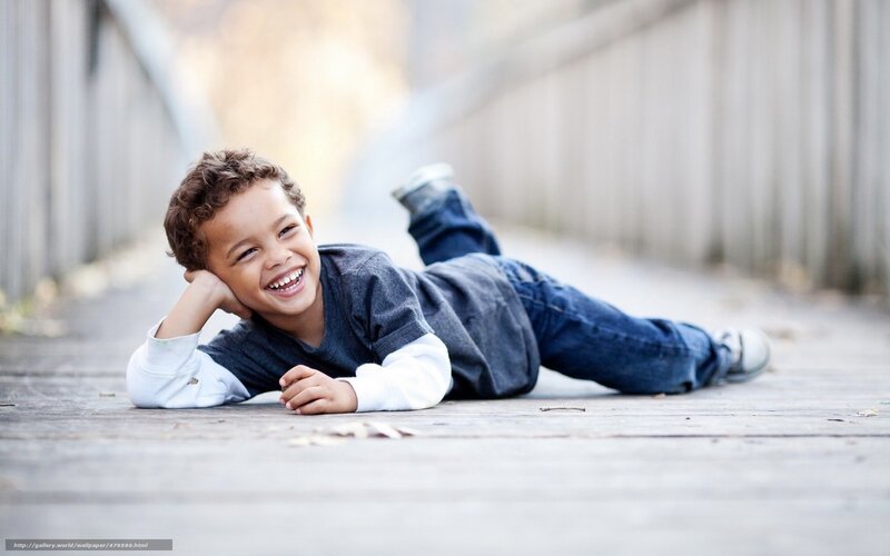 happy boy lying on ground