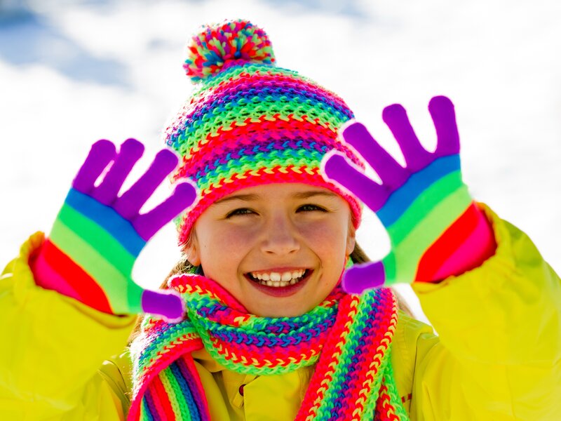 Happy child in colorful winter gear