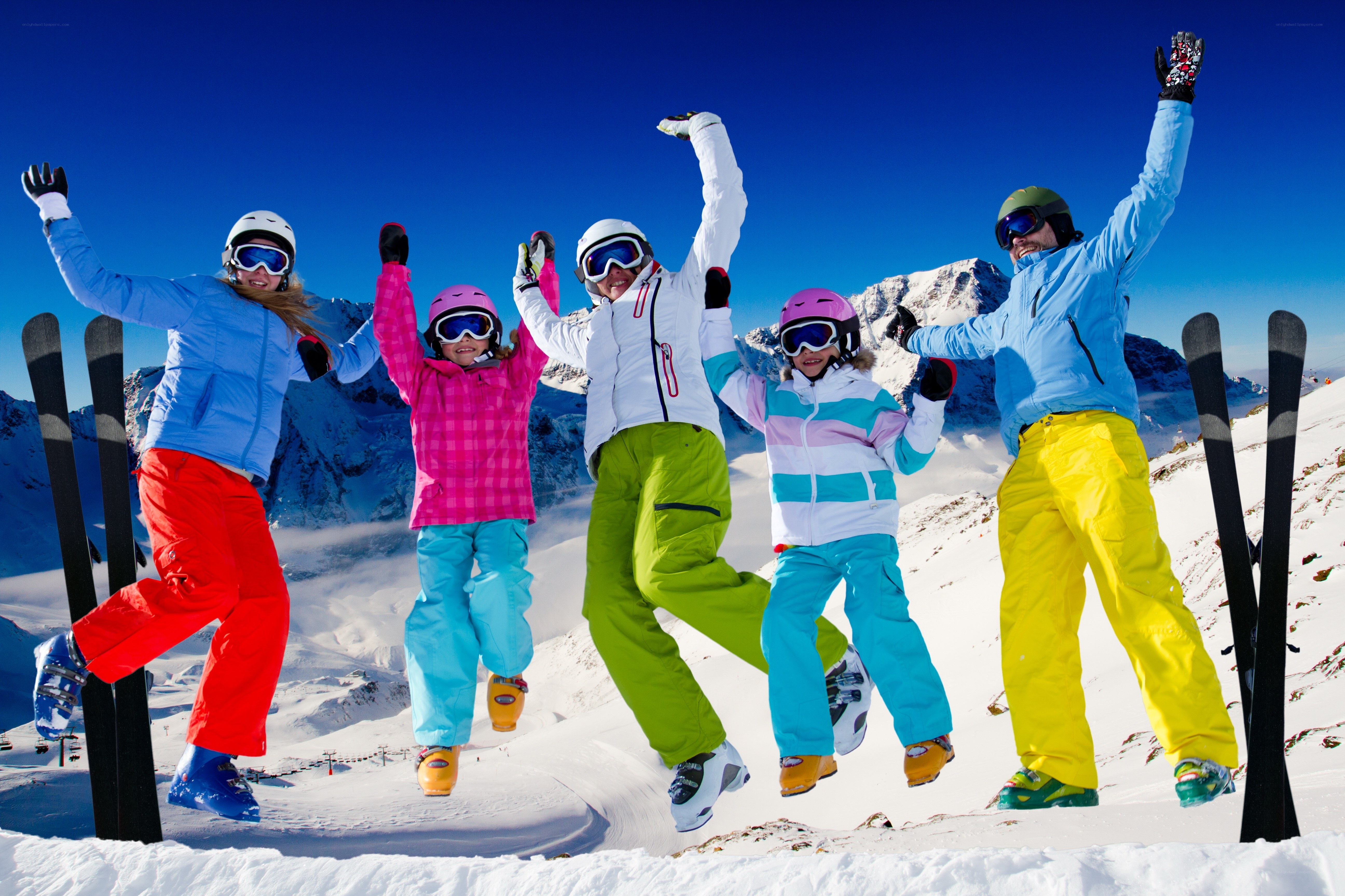 Happy skiers jumping on mountain