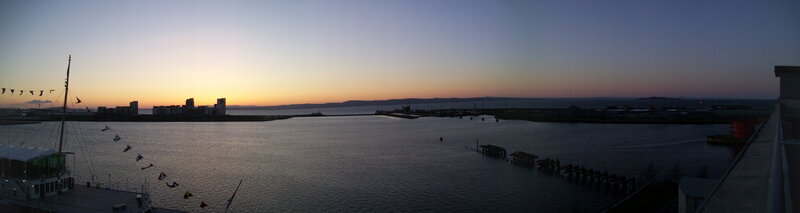 Harbor at dusk with city skyline