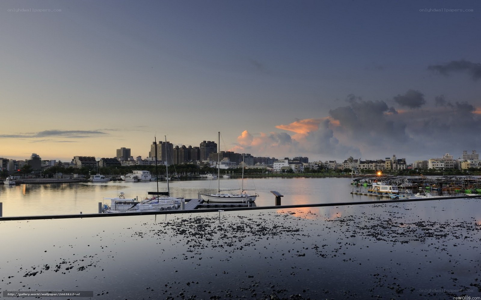 Harbor at dusk with city skyline