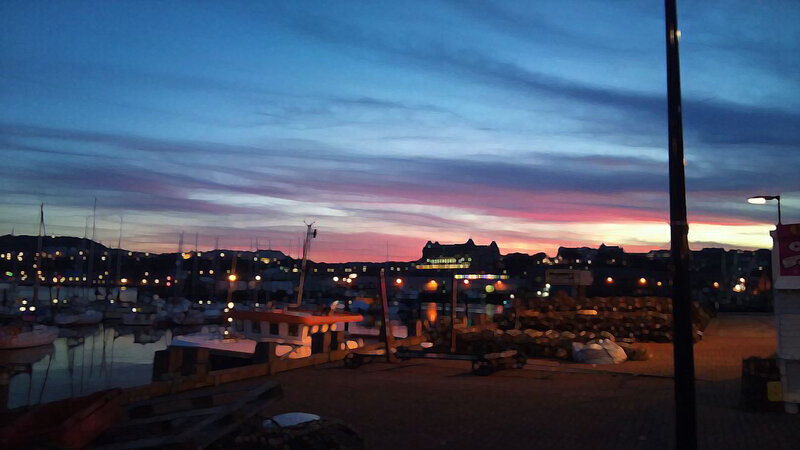 harbor at dusk with colorful sky