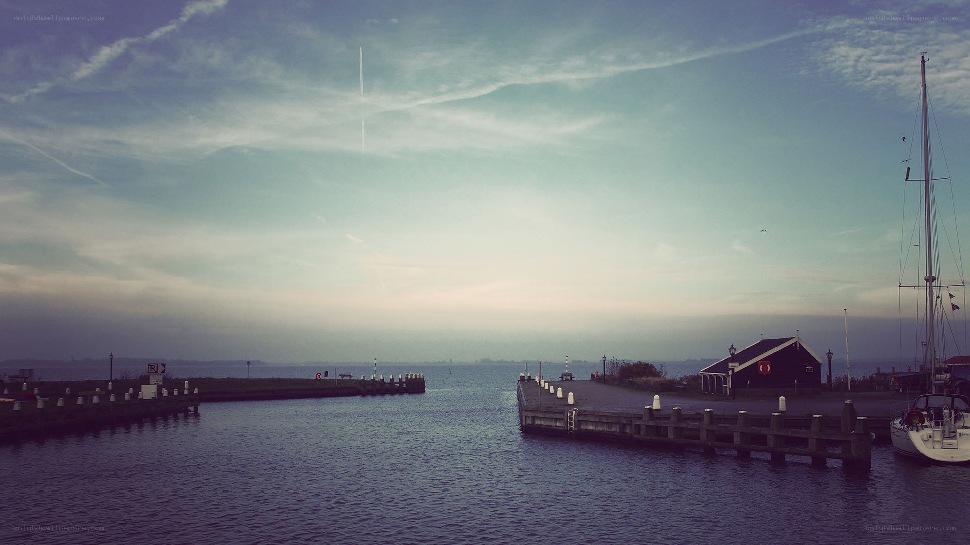harbor at dusk with sailboat