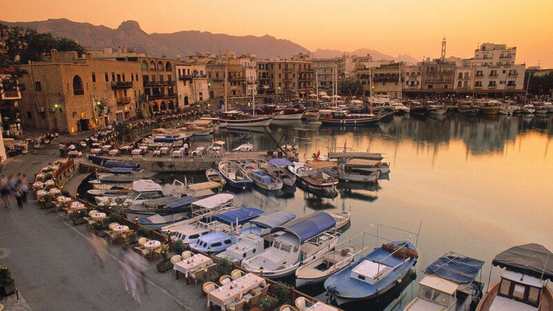 harbor at sunset with boats and buildings