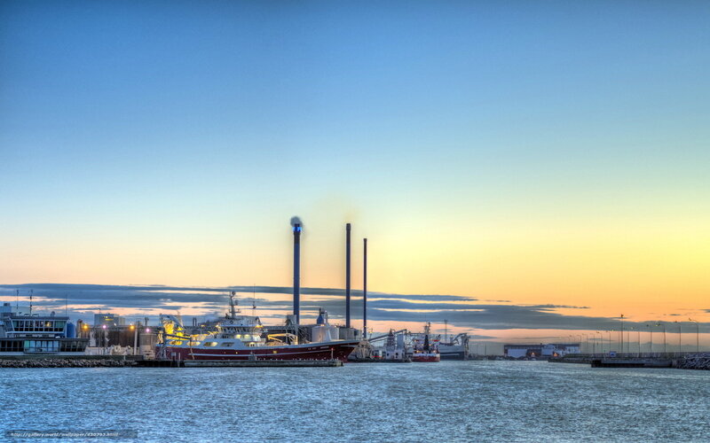 Harbor at sunset with industrial plants