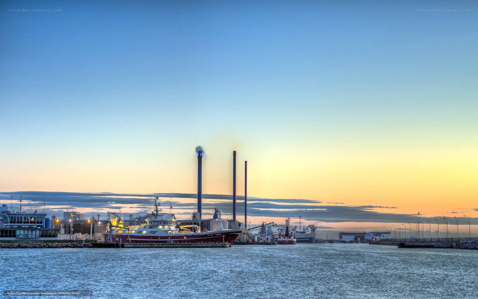 Harbor at sunset with industrial plants