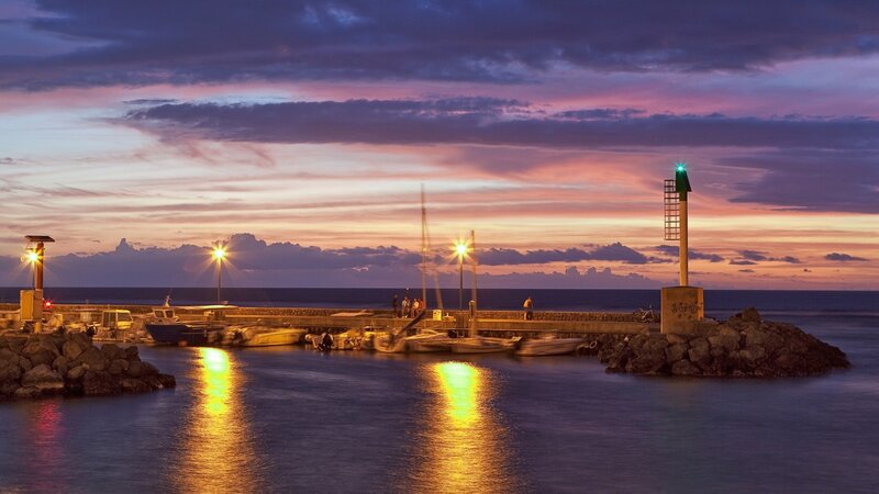 harbor at sunset with lighthouse