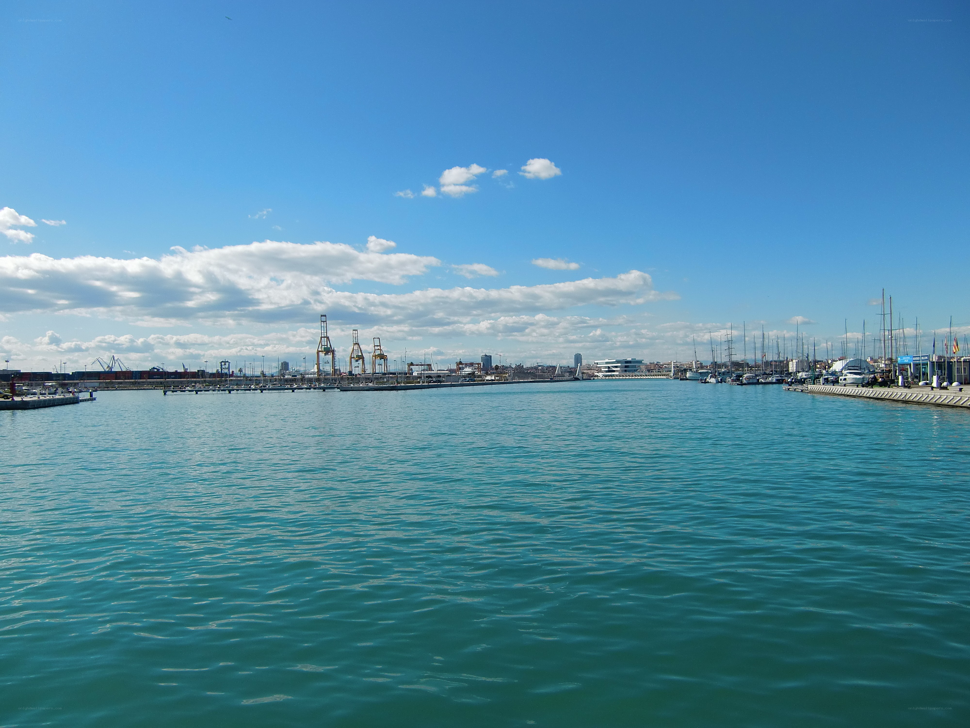harbor view with cranes and boats