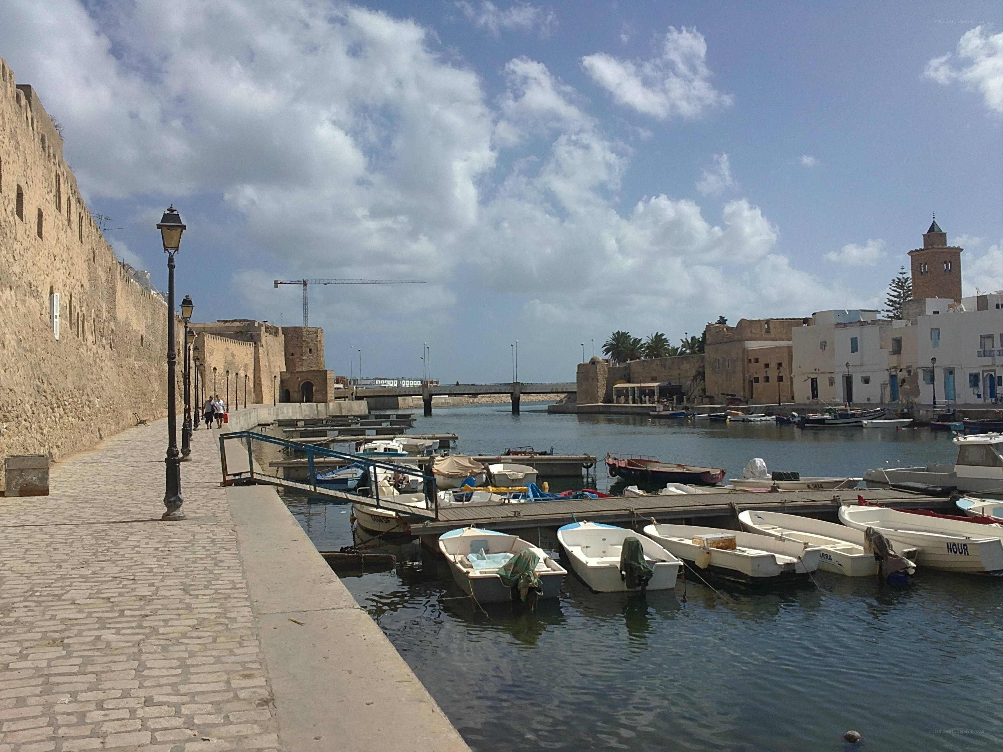 harbor with old walls and boats