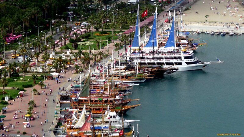 harbor with sailboats and tourists