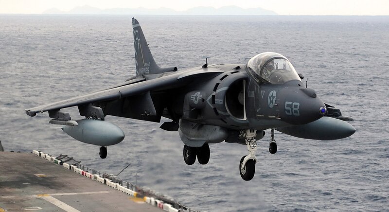 Harrier jet landing on aircraft carrier