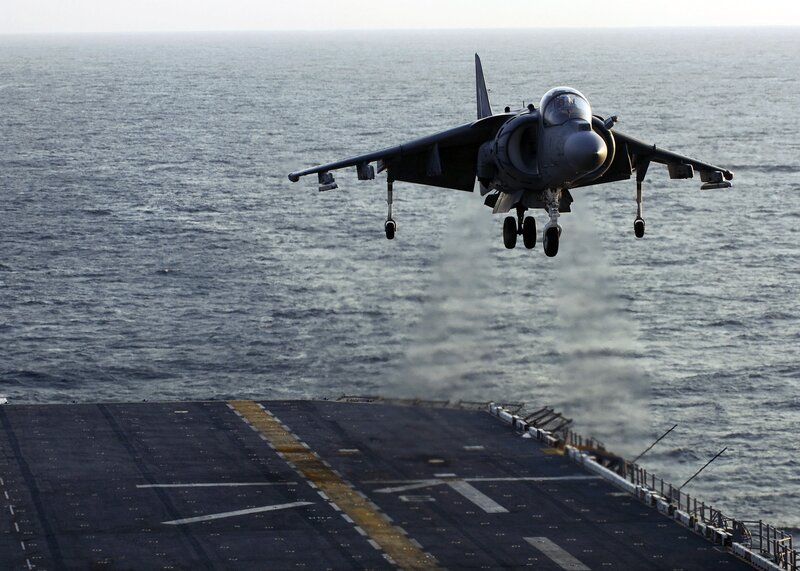 Harrier jet landing on aircraft carrier