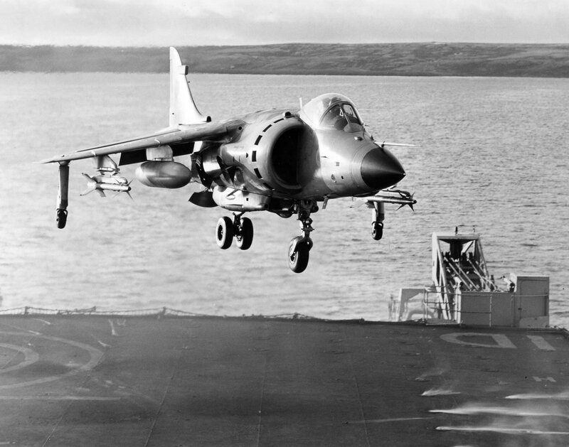 Harrier jet landing on aircraft carrier