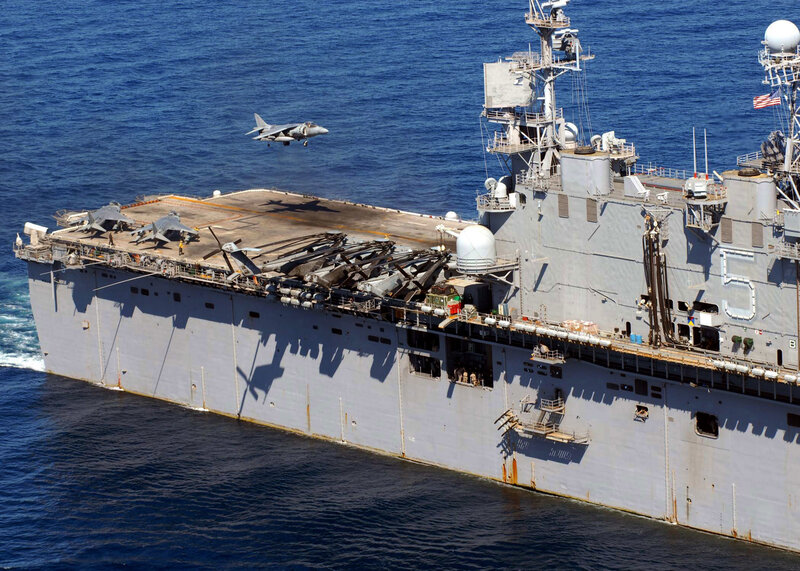 Harrier jet landing on amphibious assault ship