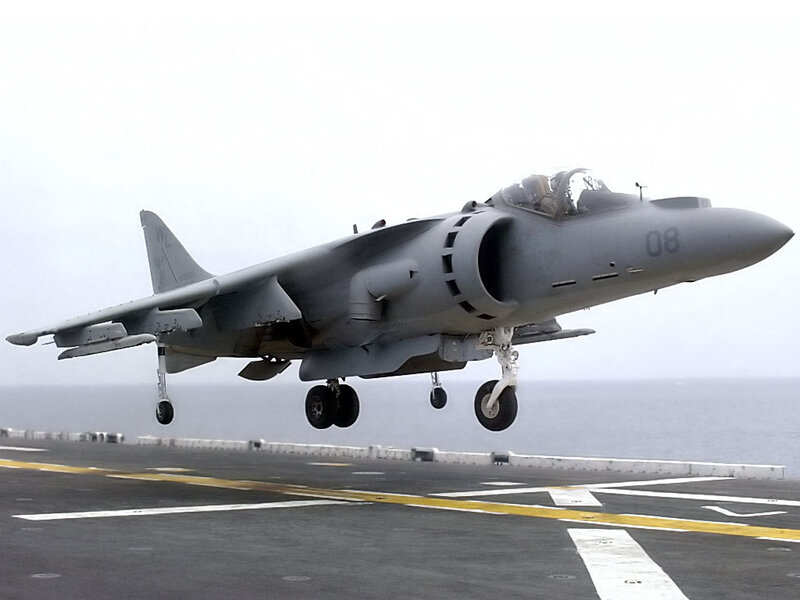 Harrier jet taking off from aircraft carrier