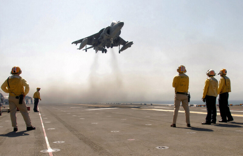Harrier jet taking off from aircraft carrier