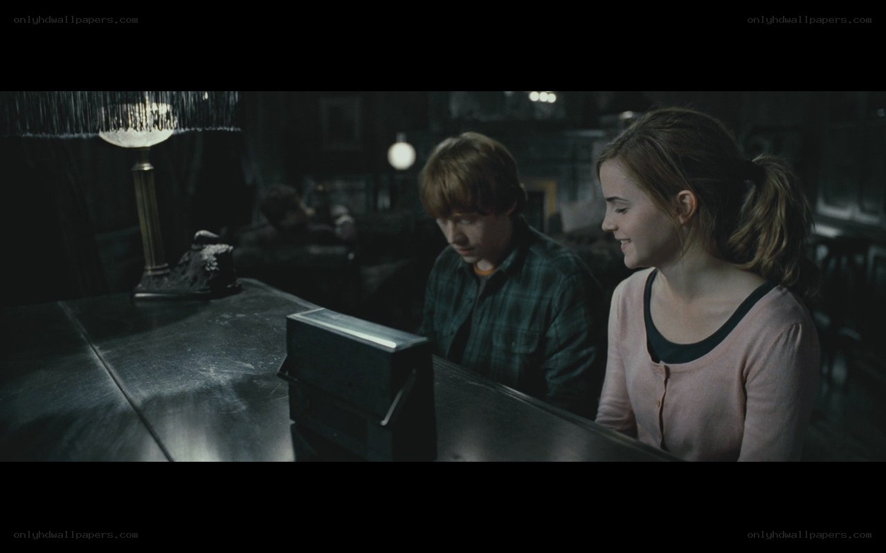Harry Potter and Ron Weasley at a table