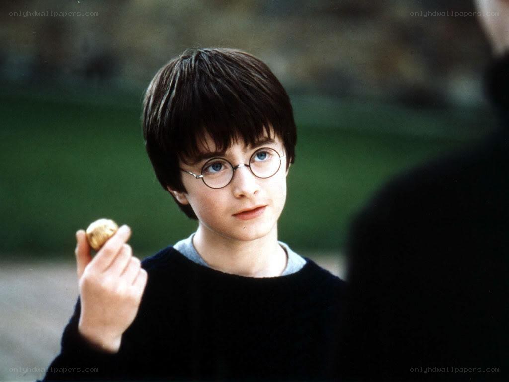 Harry Potter holding a golden object