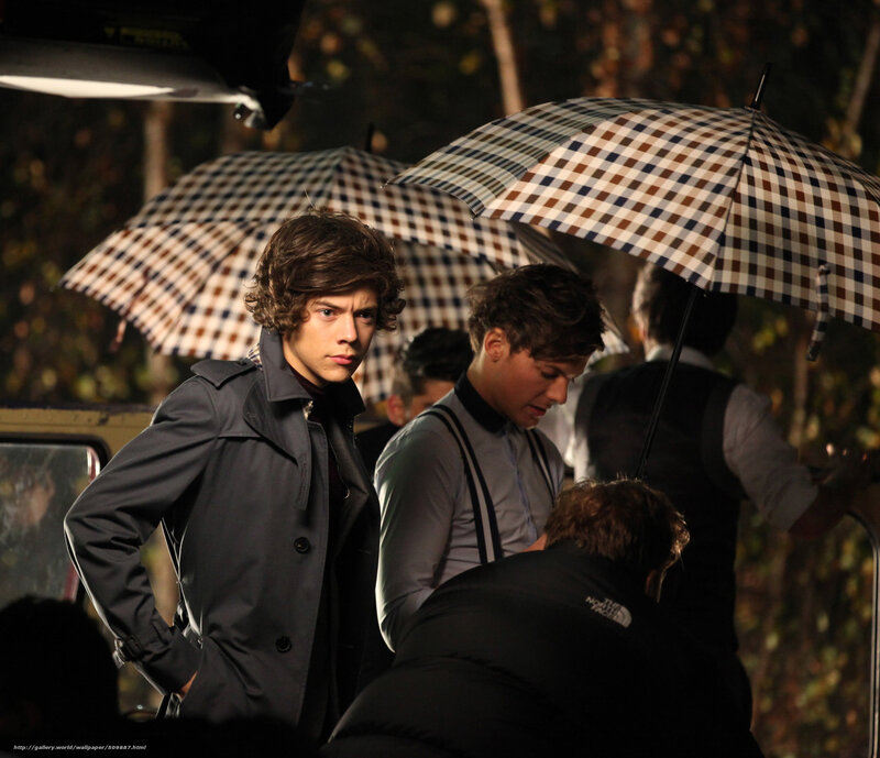 Harry Styles on set with umbrellas