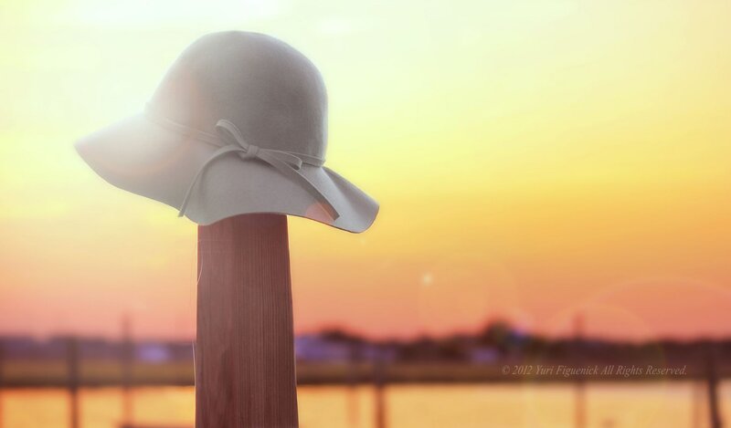 hat on a post at sunset