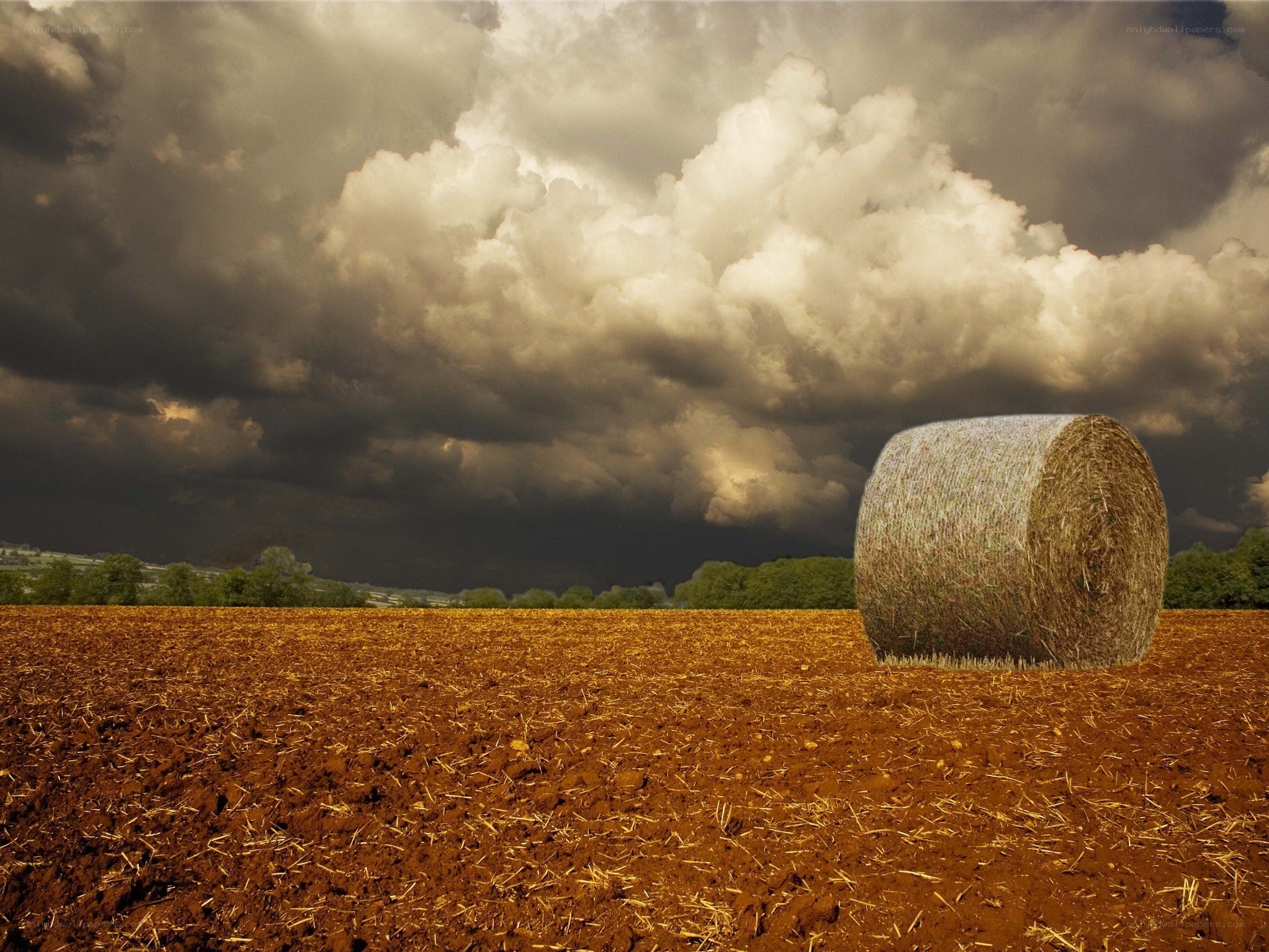Hay bale under stormy sky