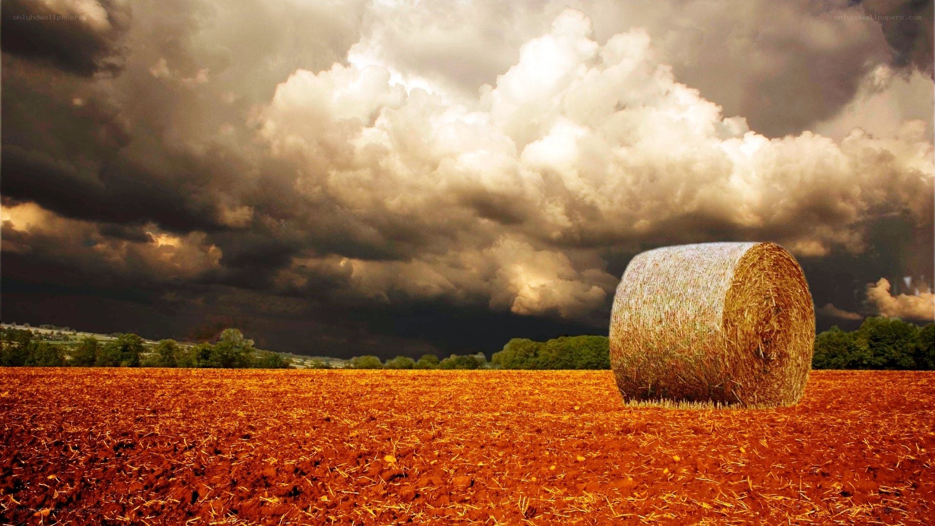 Hay bale under stormy sky