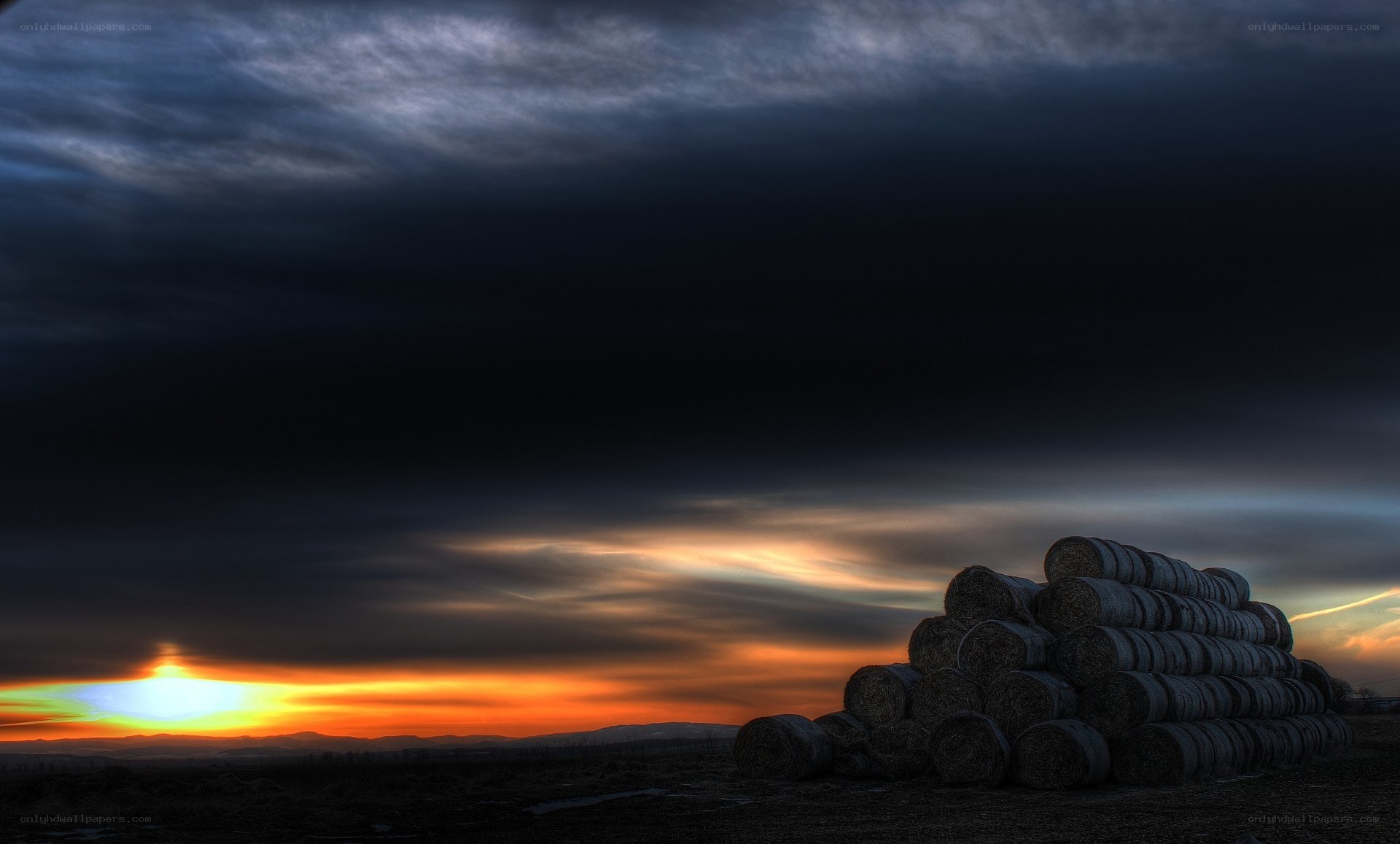 Hay bales at sunset