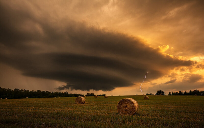 Hay Bales in Field — Brown, Dramatic, Sunset, Photograph, Storm Clouds