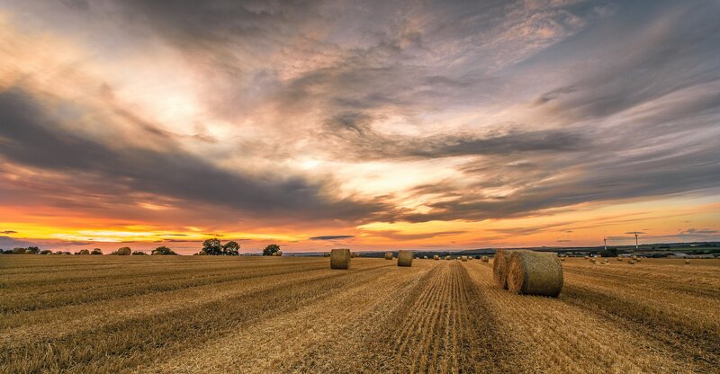 Hay Bales in Field — Orange, Dramatic, Sunset, Photograph, Sky, Clouds