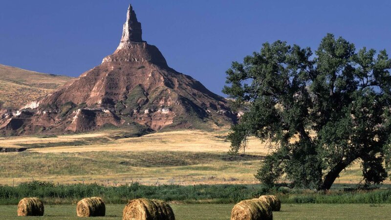 Hay bales in front of a butte