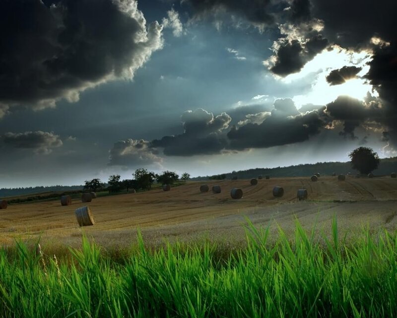 Hay bales under stormy sky