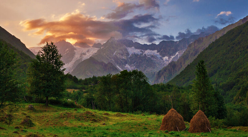 Haystacks in Mountain Valley — Green, Serene