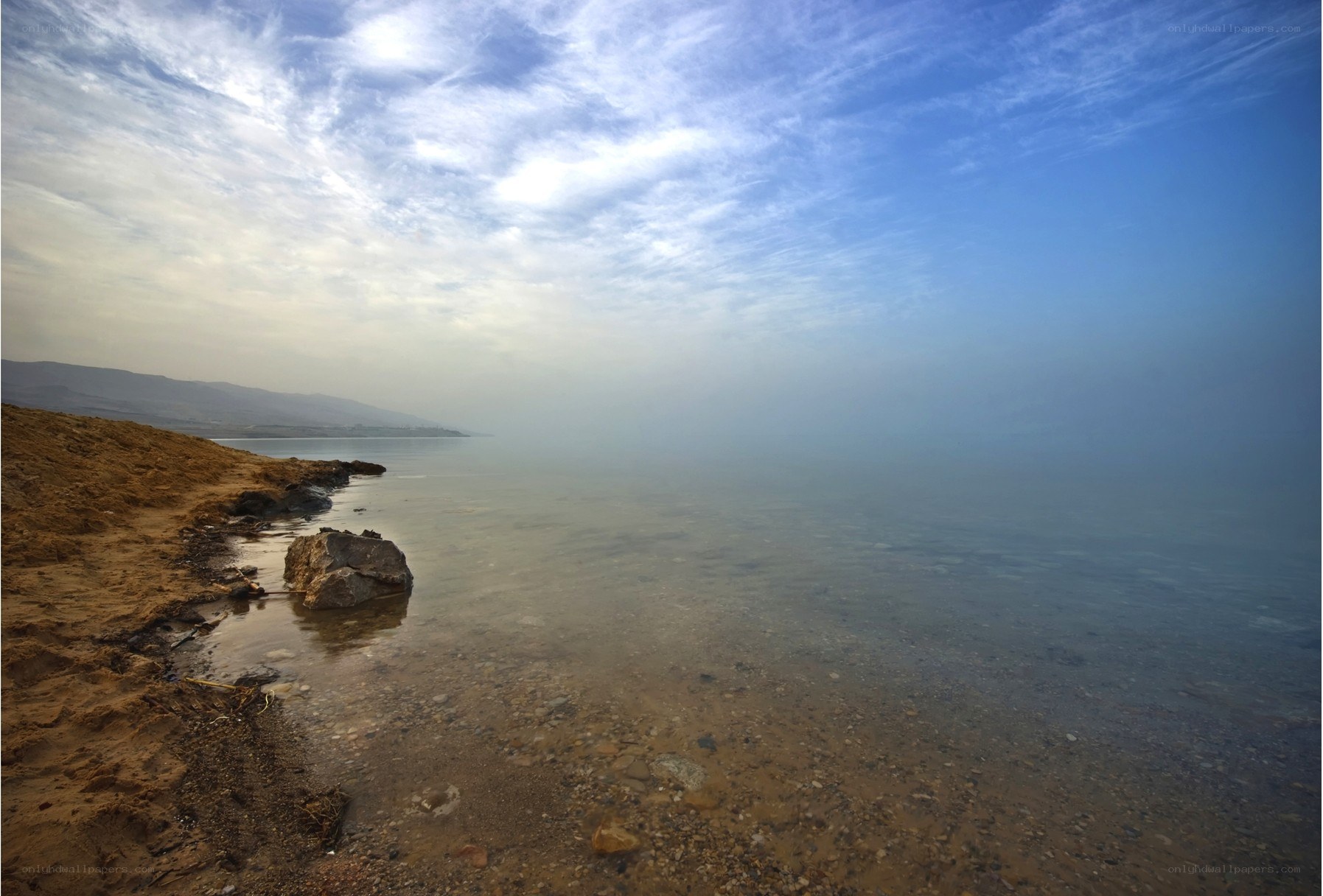 Hazy lake shore at dawn