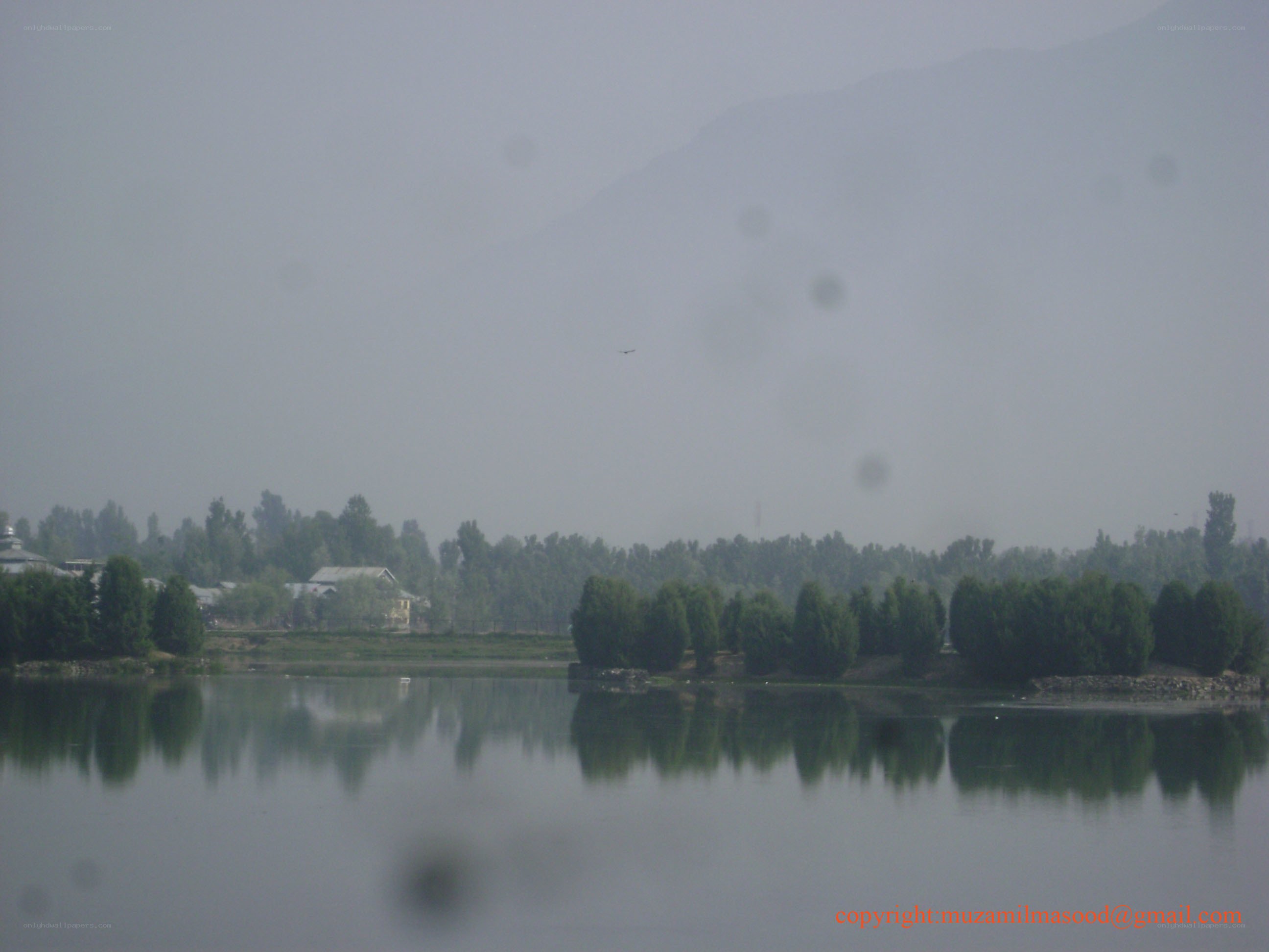 hazy lake with mountains