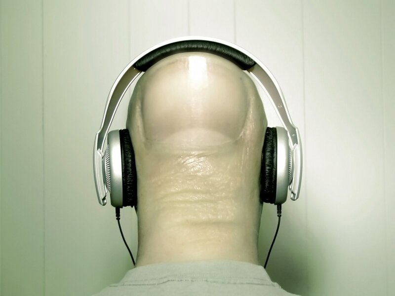 headphone-wearing man from behind